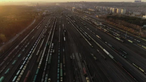 Aerial top view. Railway sorting station at sunset. Many wagons at an industrial Stock-Footage 133365469