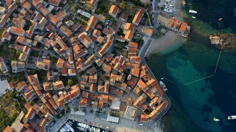 Aerial top view of red roofs in small city by blue sea in Croatia. Stock Footage 119869434