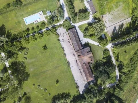 Aerial top view of a residential plot with house, trees, and a pool Fotos de archivo