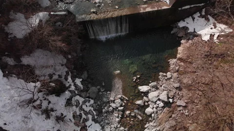 Aerial top view of a river and waterfall in Fukui, surrounded by snow Stock Footage 201263721