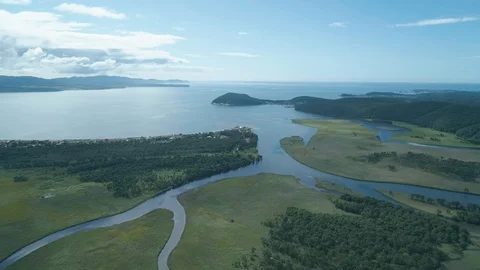 Aerial top view of river flowing into the blue sea on sunny day. Concept for Vidéo 98508464