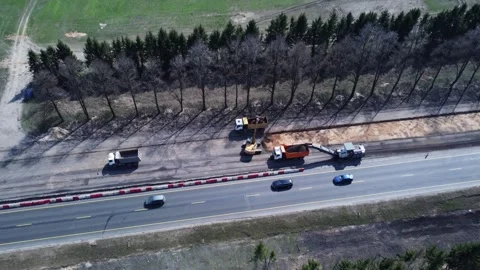 Aerial top view of road construction equipment, a dump truck, an excavator Stock Footage 307603367
