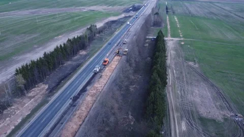 Aerial top view of road construction equipment, a dump truck, excavator Stock Footage 307603676