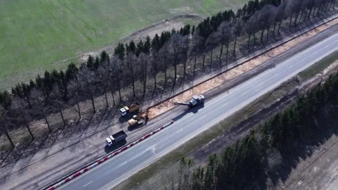 Aerial top view of road construction equipment, a dump truck, excavator Stock Footage 307603698
