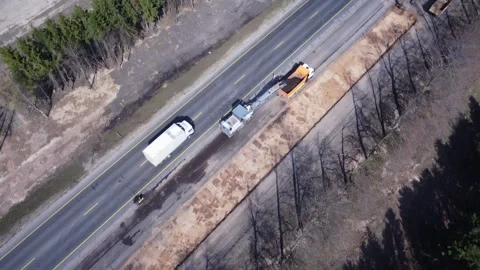 Aerial top view of road construction equipment, a dump truck, excavator Stock Footage 307603813