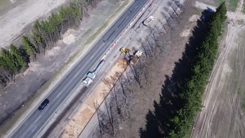 Aerial top view of road construction equipment, a dump truck, excavator Stock Footage 307603913