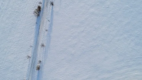 Aerial top view of the road through snowy fields Video stock 102050573
