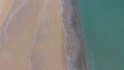 Aerial top view of sandy beach and turquoise ocean waves Stock Footage 327840247