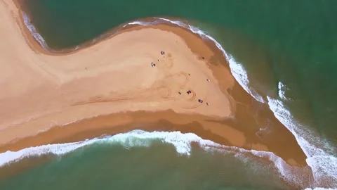 Aerial top view of sandy spit between emerald sea waves on tropical coast Stock Footage 347457760