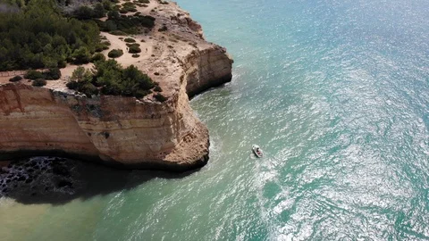 Aerial top view of sea waves hitting rocks on the beach with turquoise sea water Stock Footage 106587252