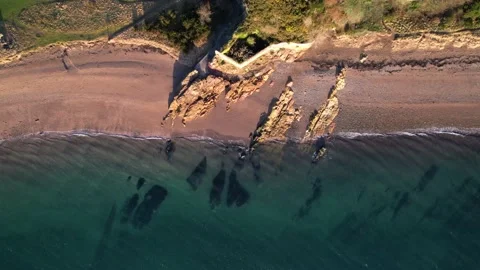 Aerial Top View of Sea Waves Reaching Rocky Beach Shore, Drone Footage Stock Footage 169970724