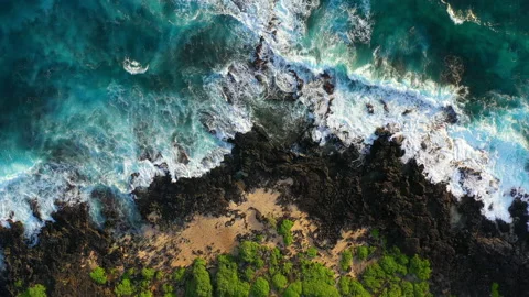 Aerial Top View Shot Of Waves Splashing On Rocks At Beach On Sunny Day - Oahu, Stock Footage 229972929