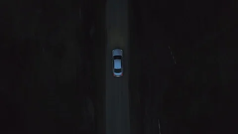 Aerial top view silver premium car Cadillac Cts driving on dark road Stock Footage 119225532