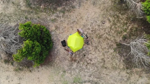 Aerial Top View Of A Single Tent In A Wild Campsite Among The Bushes On The Sand Stock Footage 195510260