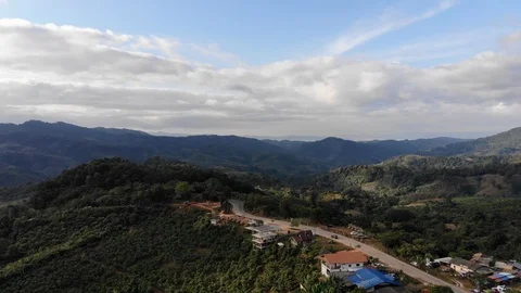 Aerial top view of sky road over top of mountain green jungle Stock Footage 106936127