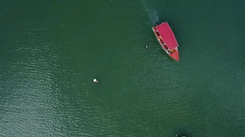 Aerial top of view of a small red boat reaching the wooden pier, Martinique Stock Footage 82658984