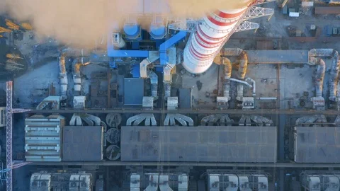 Aerial top view of smoking chimney of CHP plant (coal-fired power station) Stock Footage