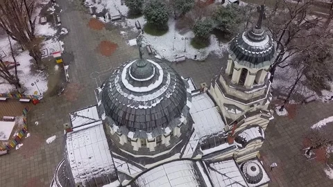 Aerial top view of snow covered orthodox cathedral in winter city Stock Footage 345448737