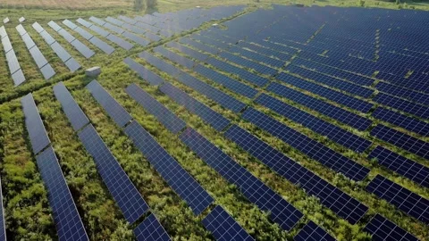 Aerial Top view on Solar Power Station in Green Field on Sunny day Stock Footage 196240509
