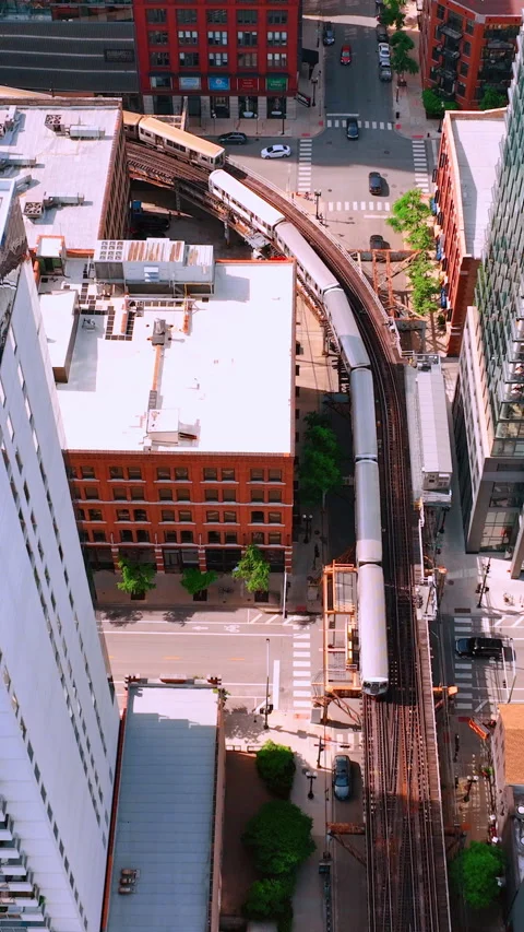 Aerial top view of a subway train moving on an elevated rail track. Stock Footage 300606343