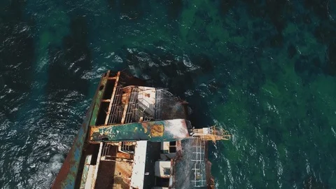 Aerial top view sunken cargo ship sticking out of the sea water Stock-Footage 118646325