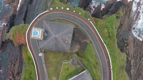 Aerial top view of surf breaking on coastal rocks 스톡 동영상 343325710