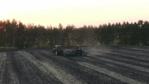 Aerial Top view, tractor plants spring wheat at sunset, sowing winter crops Stock Footage 158217872