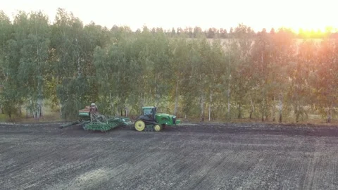 Aerial Top view, tractor plants spring wheat at sunset, sowing winter crops Stock Footage 158222703