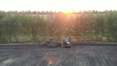 Aerial Top view, tractor plants spring wheat at sunset, sowing winter crops Stock Footage 158227603
