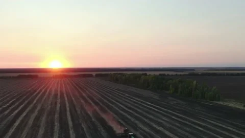 Aerial Top view, tractor plants spring wheat at sunset, sowing winter crops Stock Footage 158246443