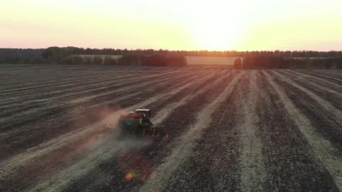 Aerial Top view, tractor plants spring wheat at sunset, sowing winter crops Stock Footage 158249452