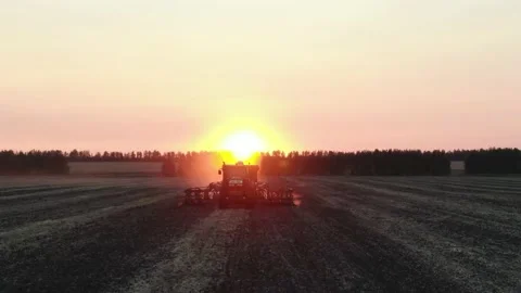 Aerial Top view, tractor plants spring wheat at sunset, sowing winter crops Stock Footage 158255291