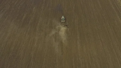 Aerial top view tractor plows a large field Stock Footage 118743014