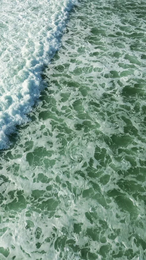 Aerial top view of turquoise ocean waves with white sea foam creating dynamic Stock-Footage 342519065