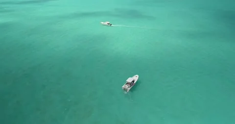 Aerial Top view two motor boats stand in the middle of caribbean sea Vidéo 221811899