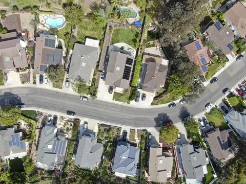 Aerial top view of upper middle class neighborhood street with residential house Stock Photos