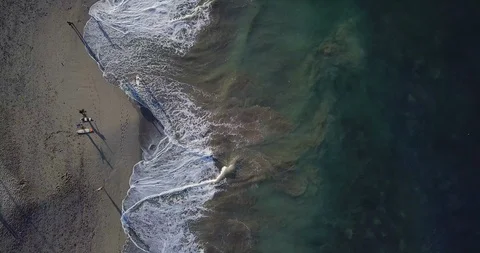 Aerial top view waves break on sand beach at sunset. Sea waves on the beautif Video stock 93274290