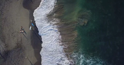 Aerial top view waves break on sand beach at sunset. Sea waves on the beautif Stock Footage 93274360