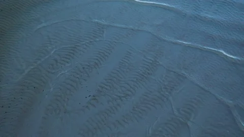 Aerial top view waves break at coast at evening Stock Footage 104631349