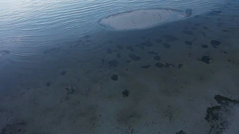Aerial top view waves break at coast little isle at evening Stock Footage 104631789