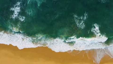 Aerial top view of waves break on tropical yellow sand beach. Ocean surf Stock Footage 119184497