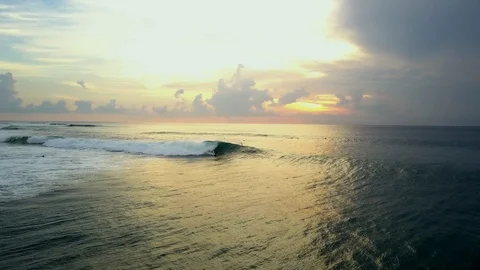 Aerial top view of  waves break with boards and sporty people surfing in ocean Stock Footage 128622376