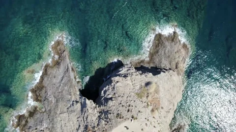 Aerial top view waves break on rocks in a blue ocean. Sea waves on beach Stock Footage 168250202