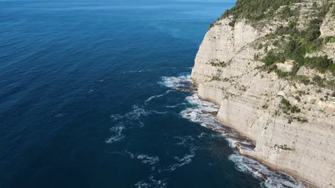 Aerial top view of waves break on rocks in a blue ocean. Sea waves on beautiful Stock Footage 176307993
