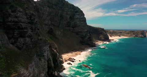 Aerial top view of waves break on rocks in a blue ocean. Sea waves on beautiful Stock Footage 230909965