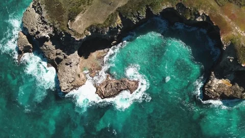 Aerial top view of waves break on rocks in a blue ocean. Sea waves on beach Stock Footage 270068161