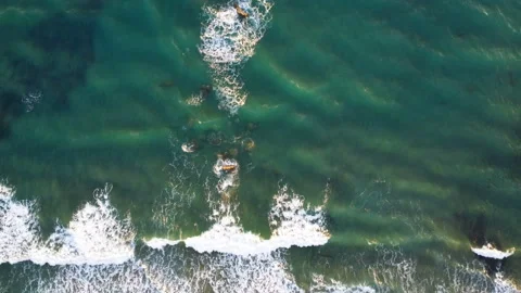 Aerial top view of waves crash motion on wild rocky sea shore,nature slowmotion Stock Footage 239541328