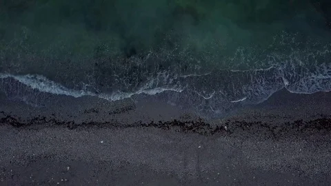 Aerial top view of waves crushing the shore Stock Footage