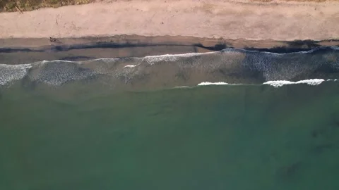 Aerial Top View Of Waves Reaching Beach, 4K Drone Footage Stock Footage