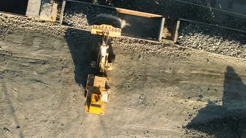 Aerial top view Wheel loader loads rock into the wagons of the train. Heavy Video stock 164713843
